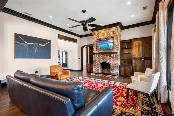 a kitchen with stainless steel appliances a dining table chairs stove refrigerator and wooden floor