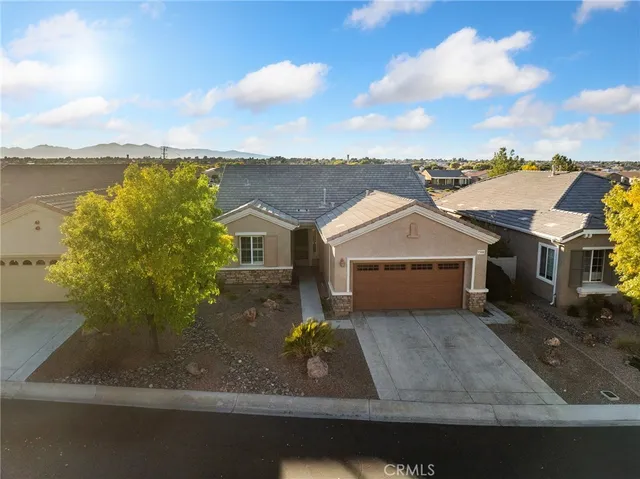 a view of a house with a yard and garage