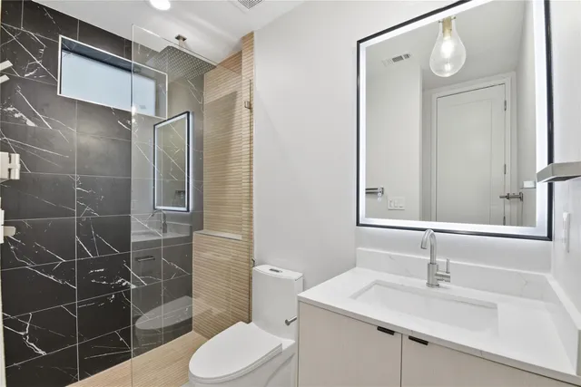 a bathroom with a sink toilet and shower