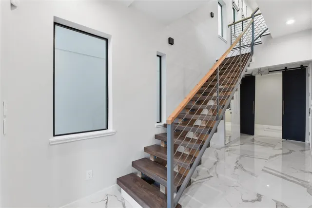 a view of entryway and hall with wooden floor