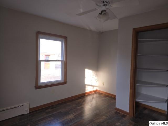 825 Augusta Road Carthage, IL 62321 - Photo 13 of 27 a view of an empty room with a window and wooden floor