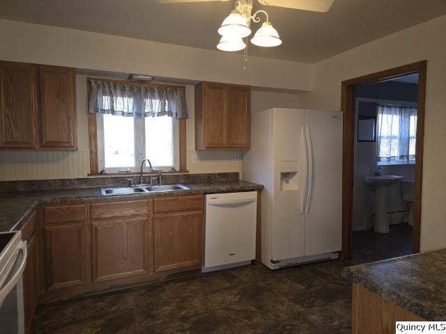 825 Augusta Road Carthage, IL 62321 - Photo 16 of 27 a kitchen with stainless steel appliances granite countertop a refrigerator and a sink