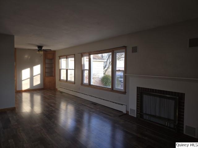 825 Augusta Road Carthage, IL 62321 - Photo 4 of 27 wooden floor in an empty room with a window