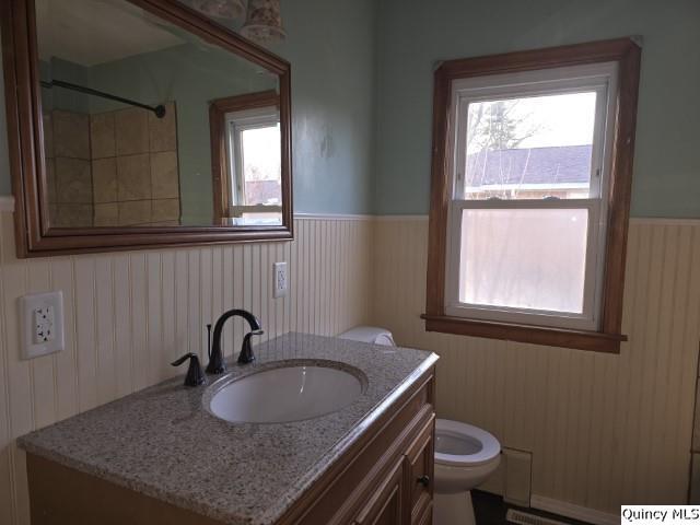 825 Augusta Road Carthage, IL 62321 - Photo 10 of 27 a bathroom with a granite countertop sink toilet a mirror and window