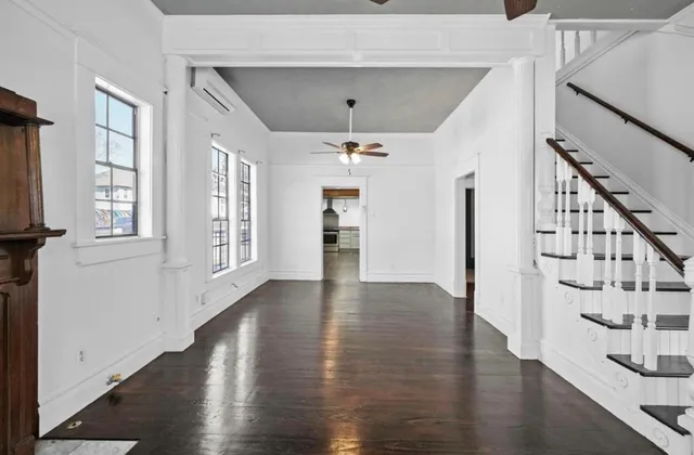 wooden floor in an empty room with a window and wooden floor