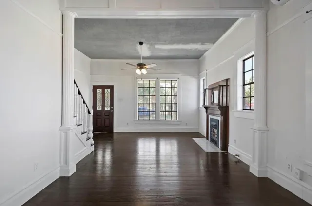 wooden floor in an empty room with a window