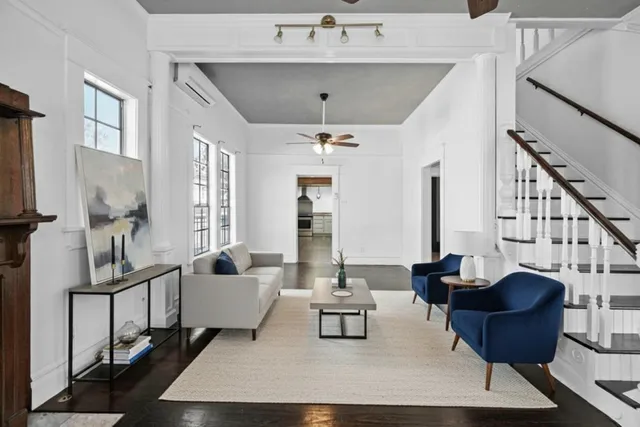a living room with furniture and a chandelier