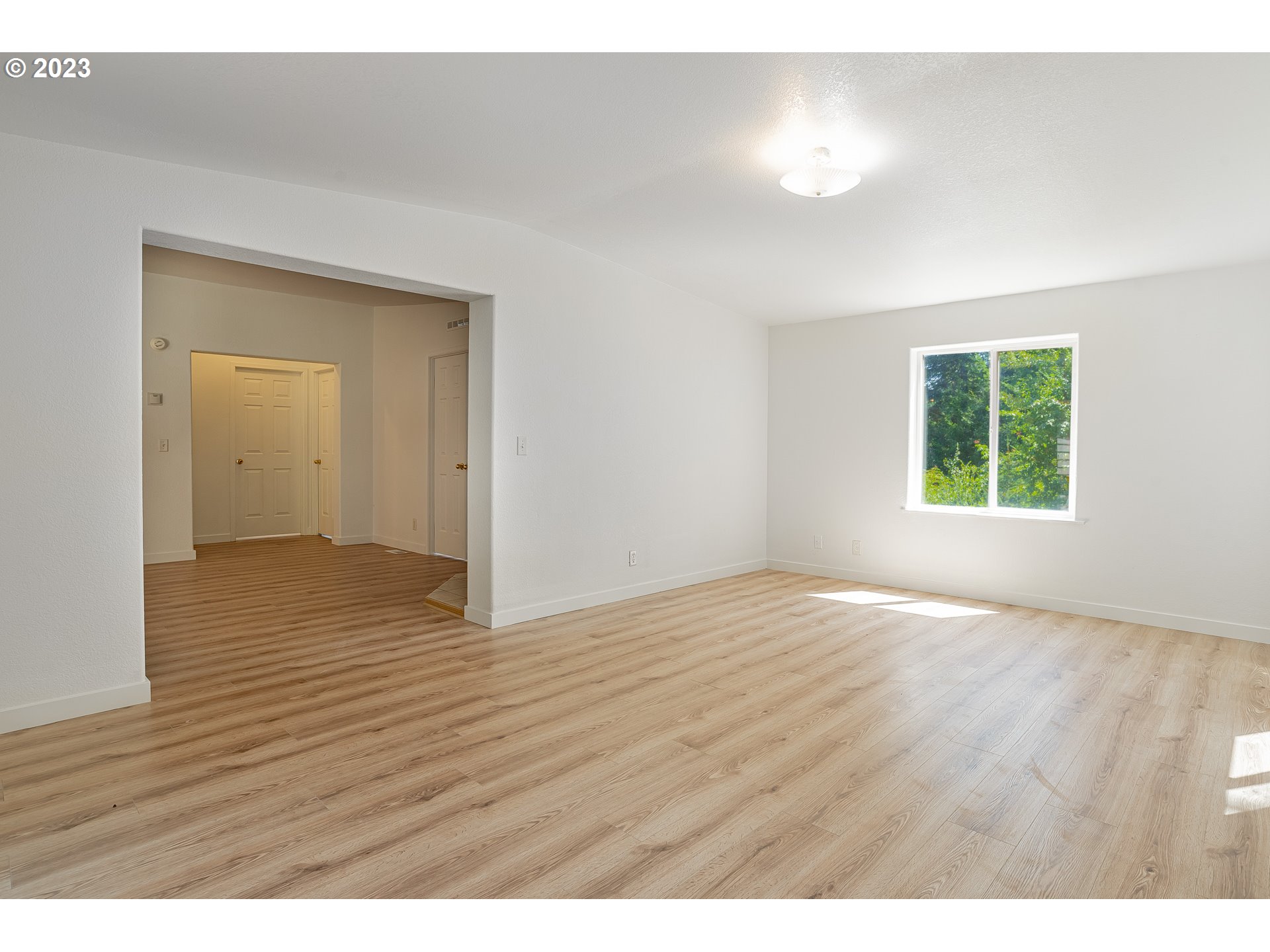 21 Nash Road White Salmon, WA 98672 - Photo 12 of 46 a view of an empty room with wooden floor and a window