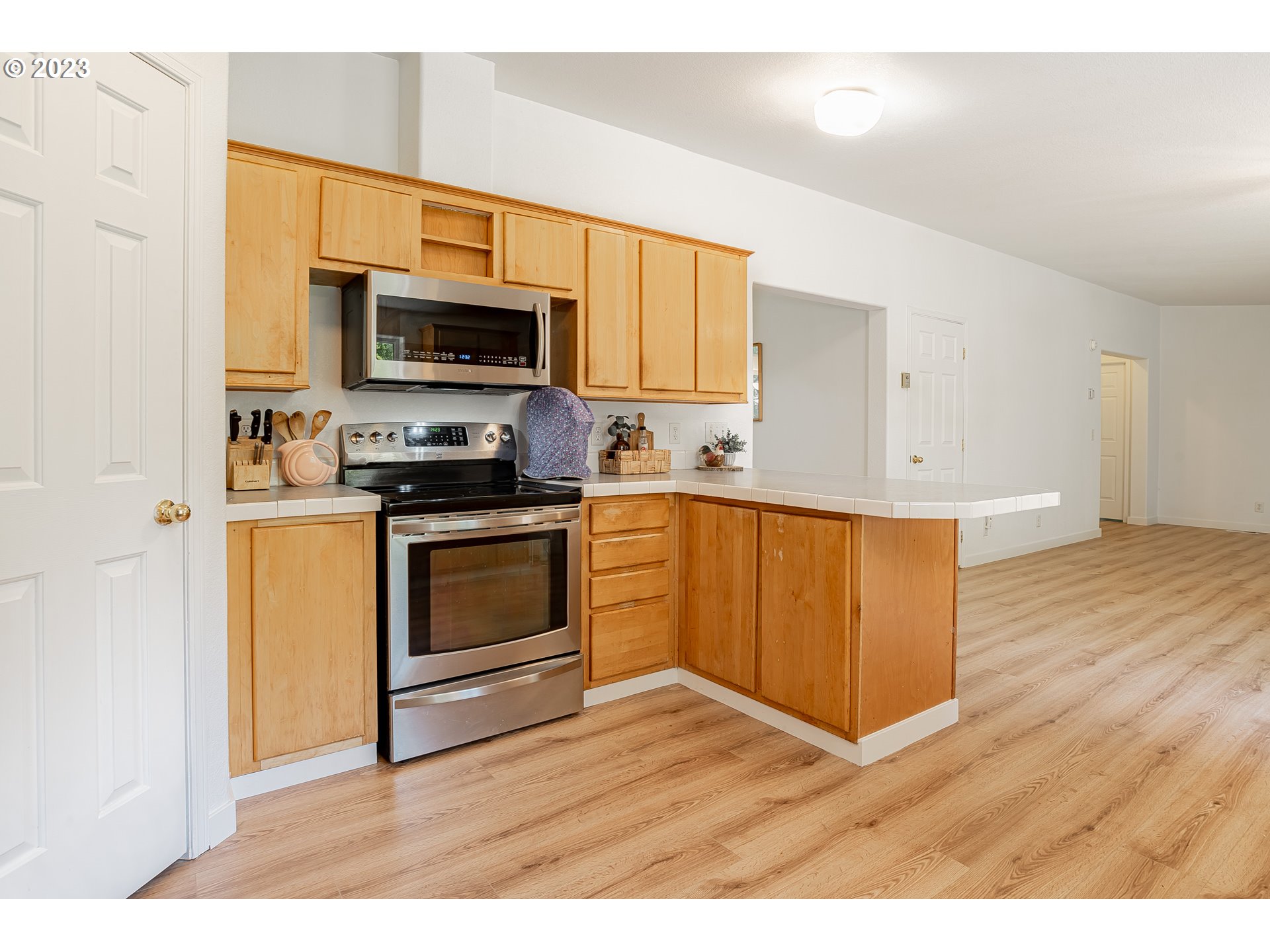21 Nash Road White Salmon, WA 98672 - Photo 8 of 46 a kitchen with stainless steel appliances a stove top oven a sink and a microwave