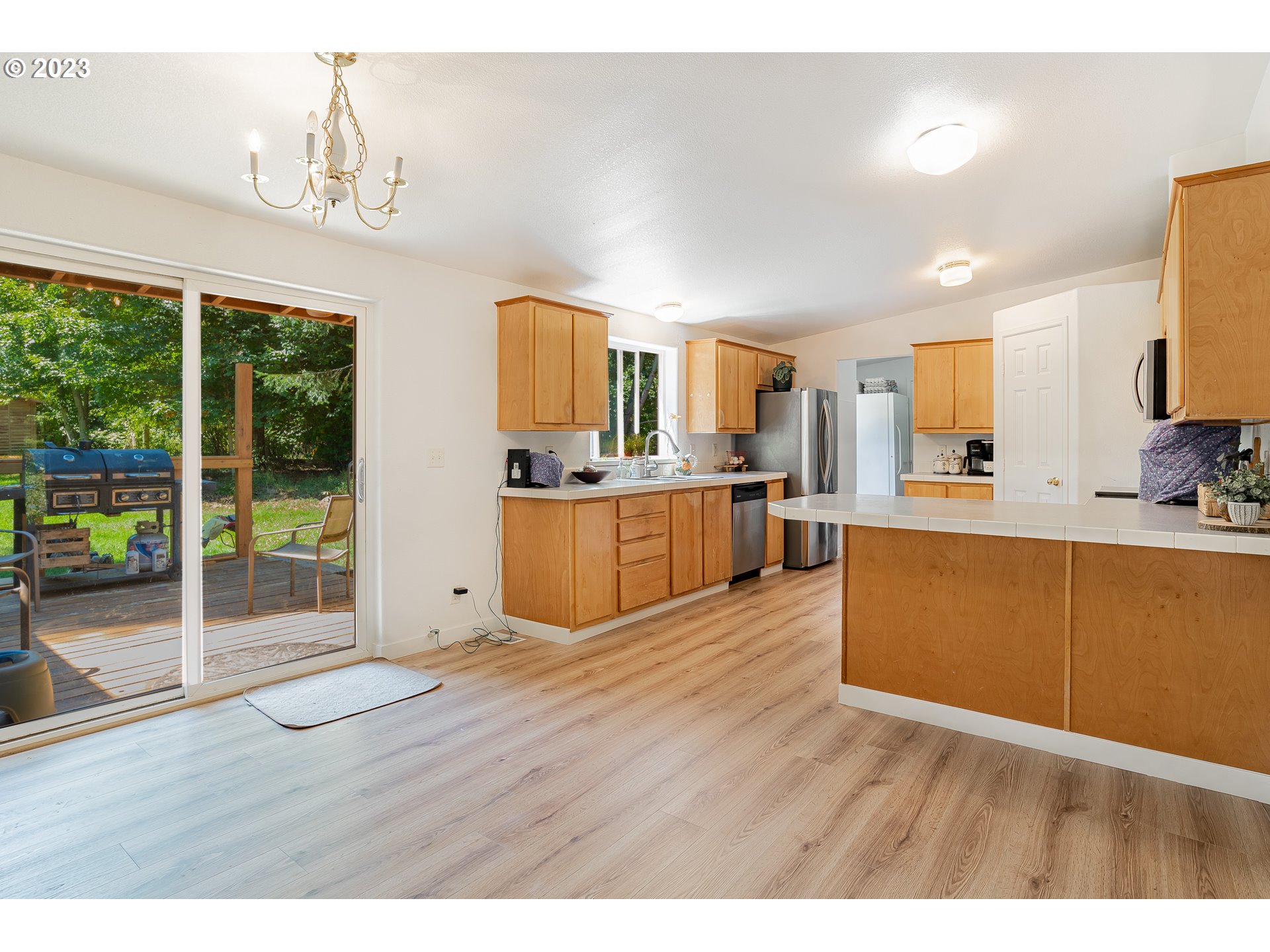 21 Nash Road White Salmon, WA 98672 - Photo 9 of 46 a large kitchen with kitchen island a large counter space a sink appliances and cabinets