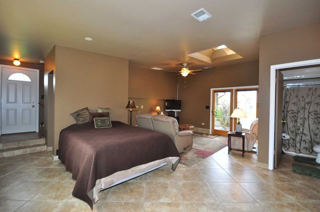 4N350 Walter Road Addison, IL 60101 - Photo 22 of 25 a bedroom with a large bed and a chandelier