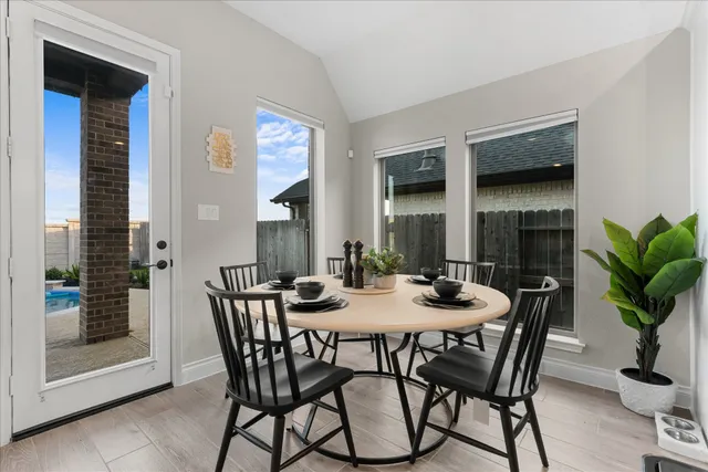 a view of a dining room with furniture and window
