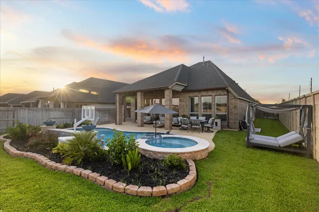 a view of a house with swimming pool and porch