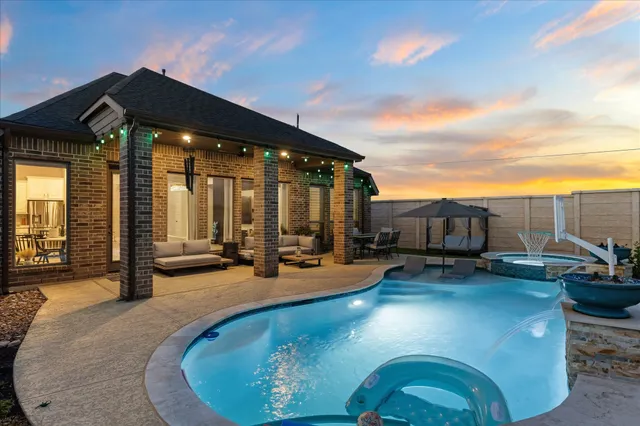 a view of a house with swimming pool and sitting area