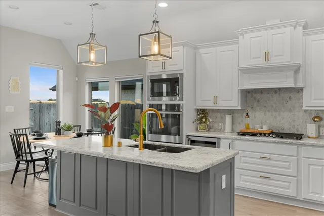 a kitchen with a counter space cabinets and appliances
