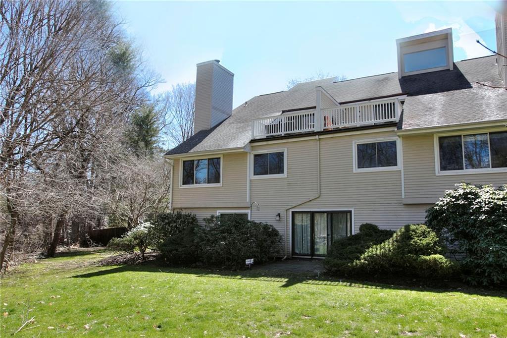 301 Post Road East, Unit 20 Westport, CT 06880 - Photo 1 of 1 a front view of a house with a yard and trees