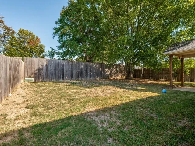a view of swimming pool with wooden fence