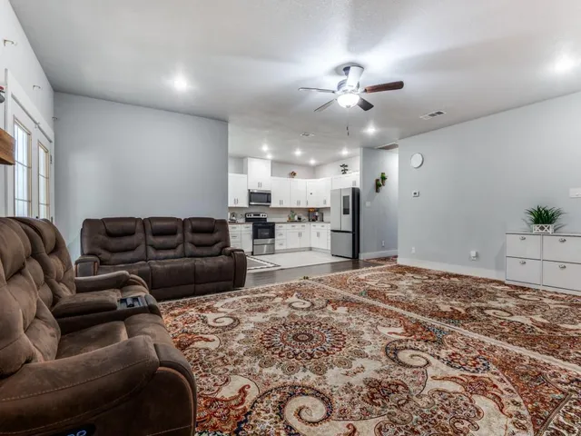 a living room with furniture and a chandelier