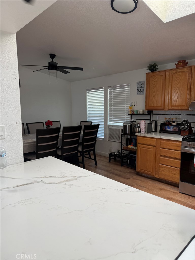12700 Elliott, Unit 98 El Monte, CA 91732 - Photo 14 of 43 a kitchen with stainless steel appliances kitchen island granite countertop a refrigerator and a stove top oven