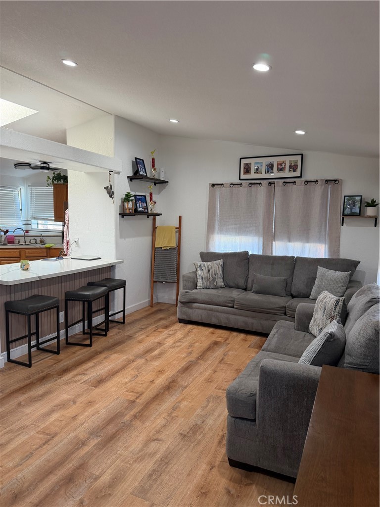 12700 Elliott, Unit 98 El Monte, CA 91732 - Photo 18 of 43 a living room with furniture and a kitchen view