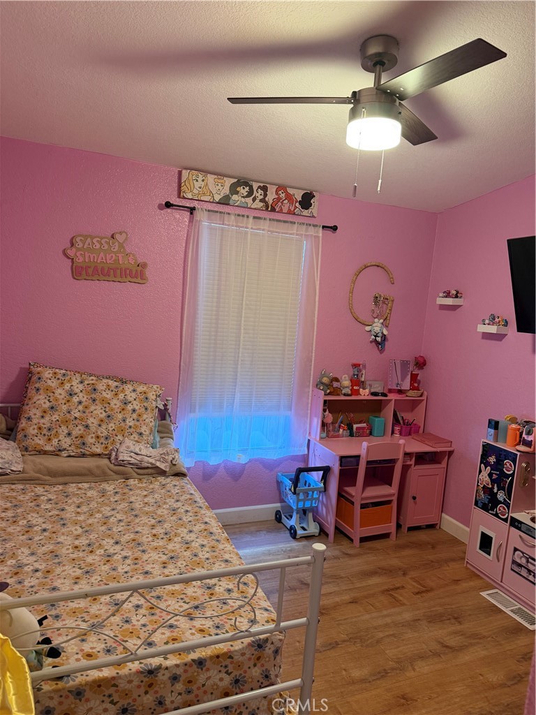 12700 Elliott, Unit 98 El Monte, CA 91732 - Photo 25 of 43 a bedroom with a bed and a chandelier