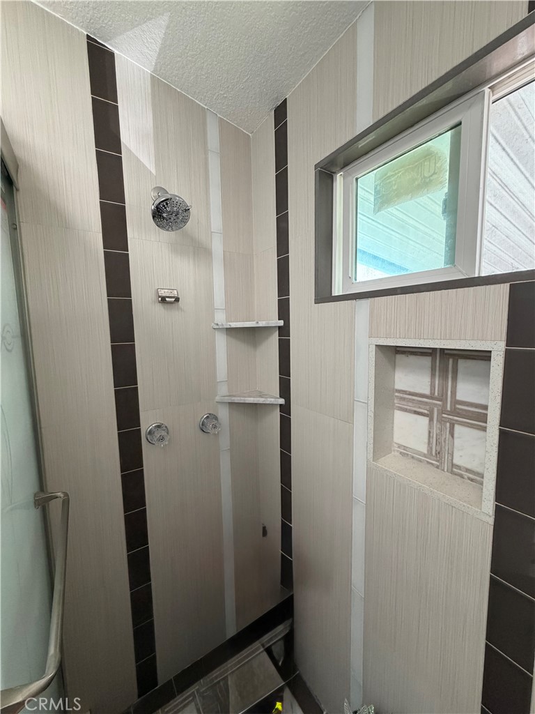 12700 Elliott, Unit 98 El Monte, CA 91732 - Photo 41 of 43 a bathroom with a glass door shower and a sink