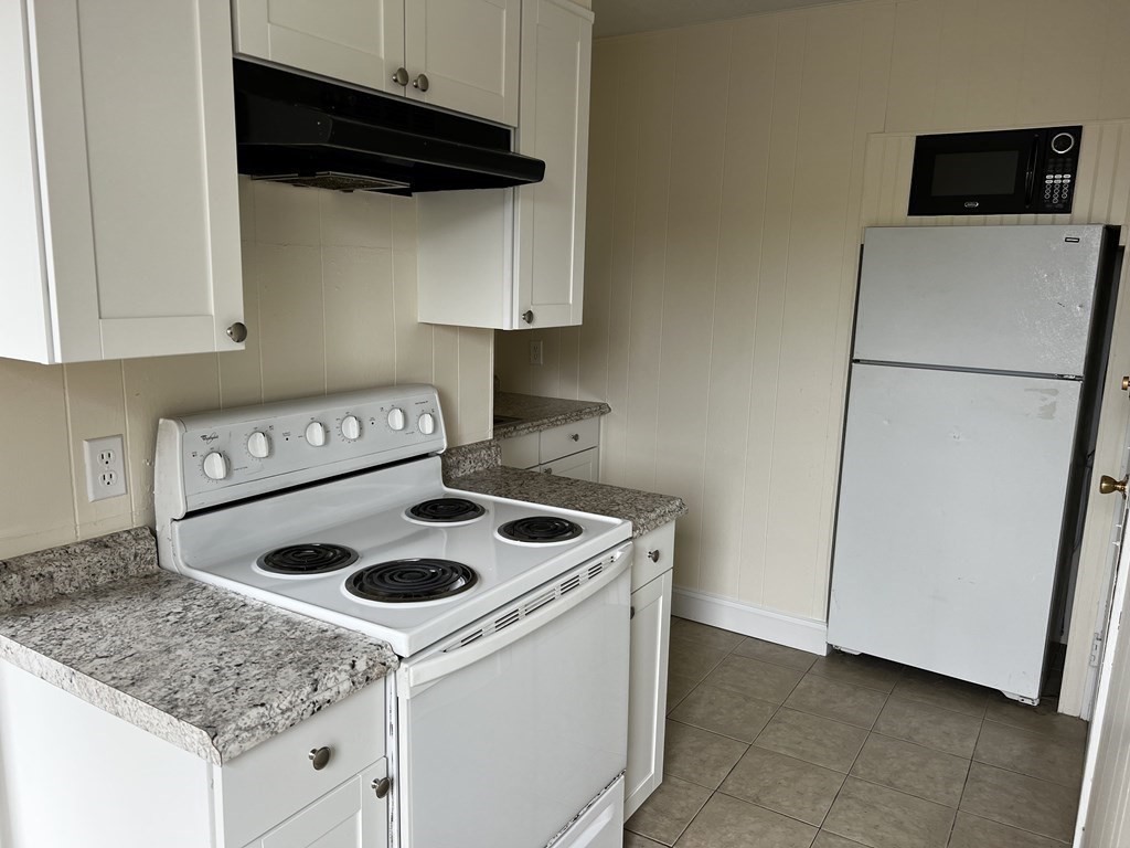 452 Main Street, Unit 1 Melrose, MA 02176 - Photo 1 of 10 a kitchen with a stove and a refrigerator