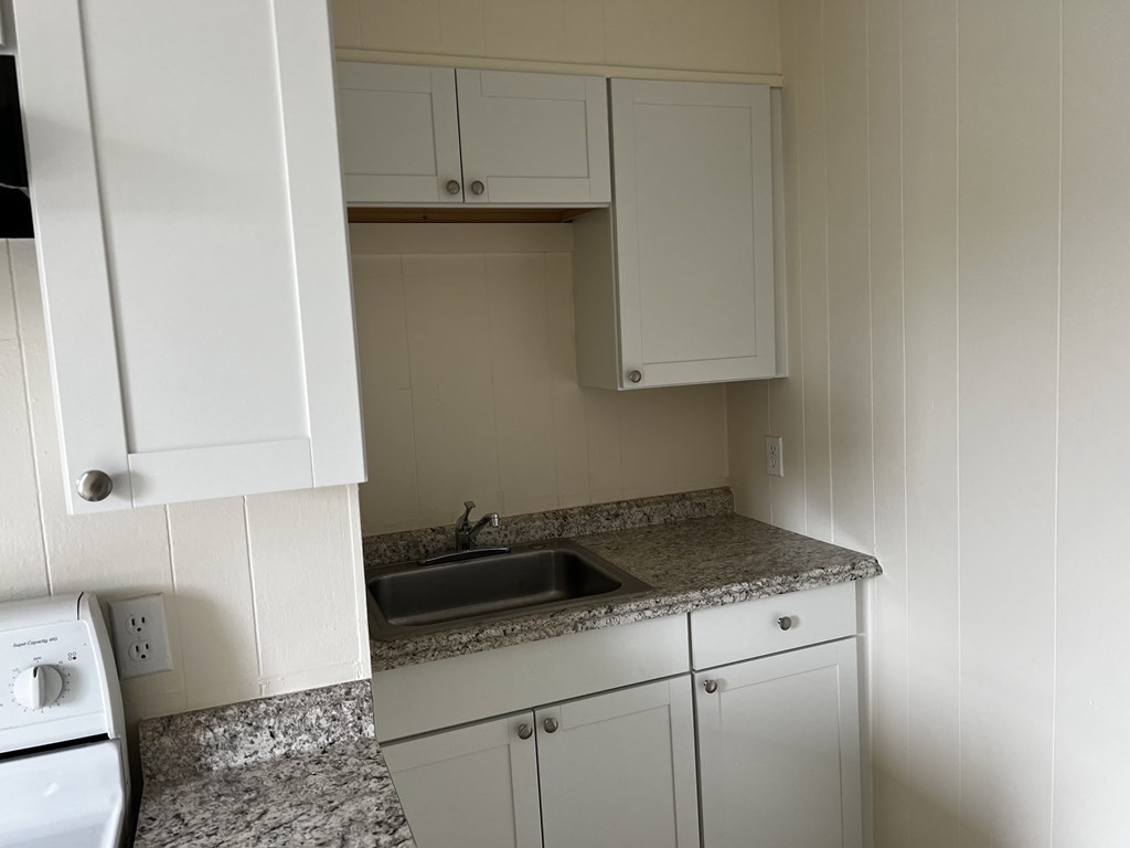 452 Main Street, Unit 1 Melrose, MA 02176 - Photo 2 of 10 a kitchen with a sink and cabinets