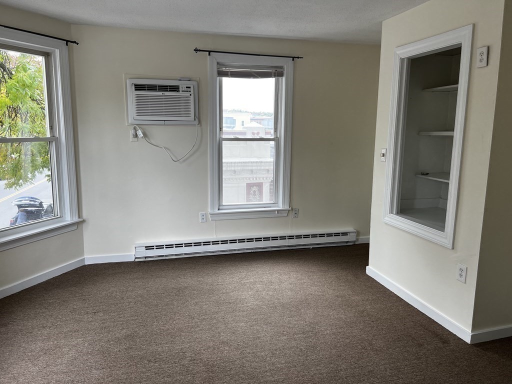 452 Main Street, Unit 1 Melrose, MA 02176 - Photo 4 of 10 an empty room with a window