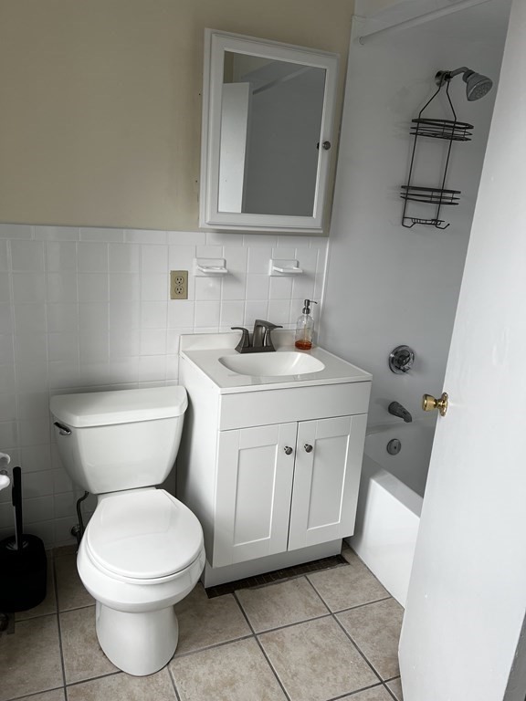 452 Main Street, Unit 1 Melrose, MA 02176 - Photo 6 of 10 a bathroom with a toilet sink and mirror