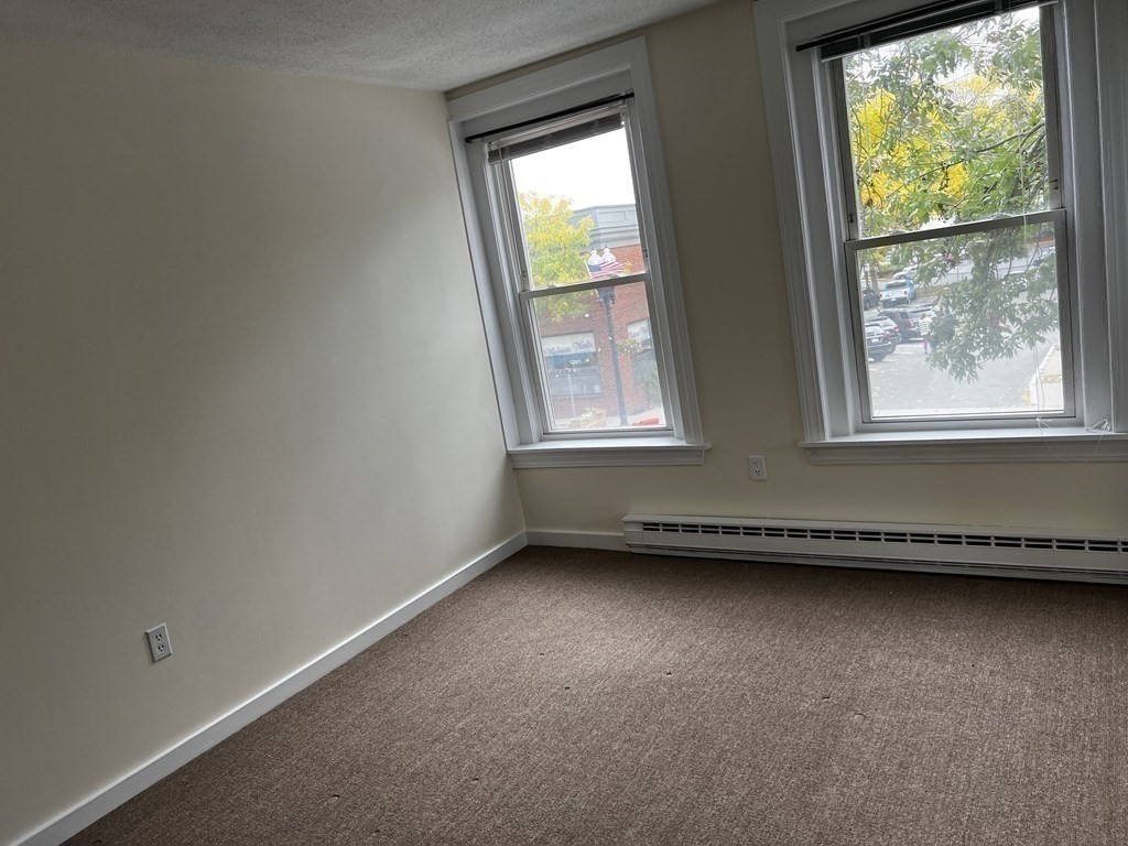 452 Main Street, Unit 1 Melrose, MA 02176 - Photo 8 of 10 an empty room with a window