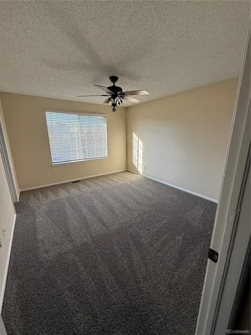 a view of a livingroom with a ceiling fan and window