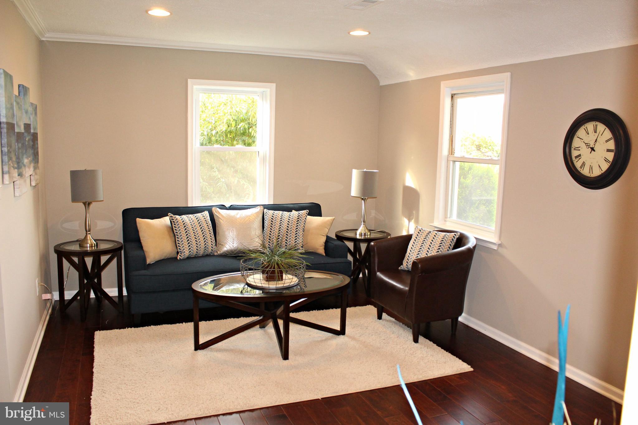 7815 Meath Road Baltimore, MD 21222 - Photo 1 of 17 a living room with furniture a window and a table