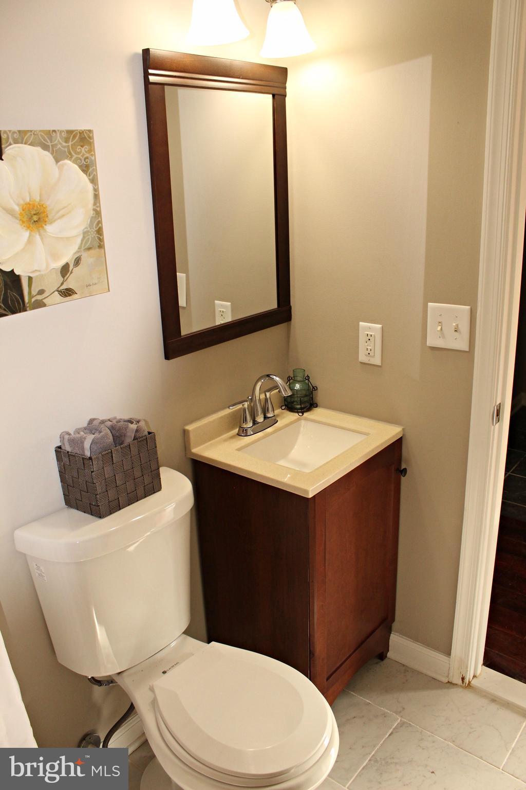 7815 Meath Road Baltimore, MD 21222 - Photo 11 of 17 a bathroom with a sink a mirror and a toilet