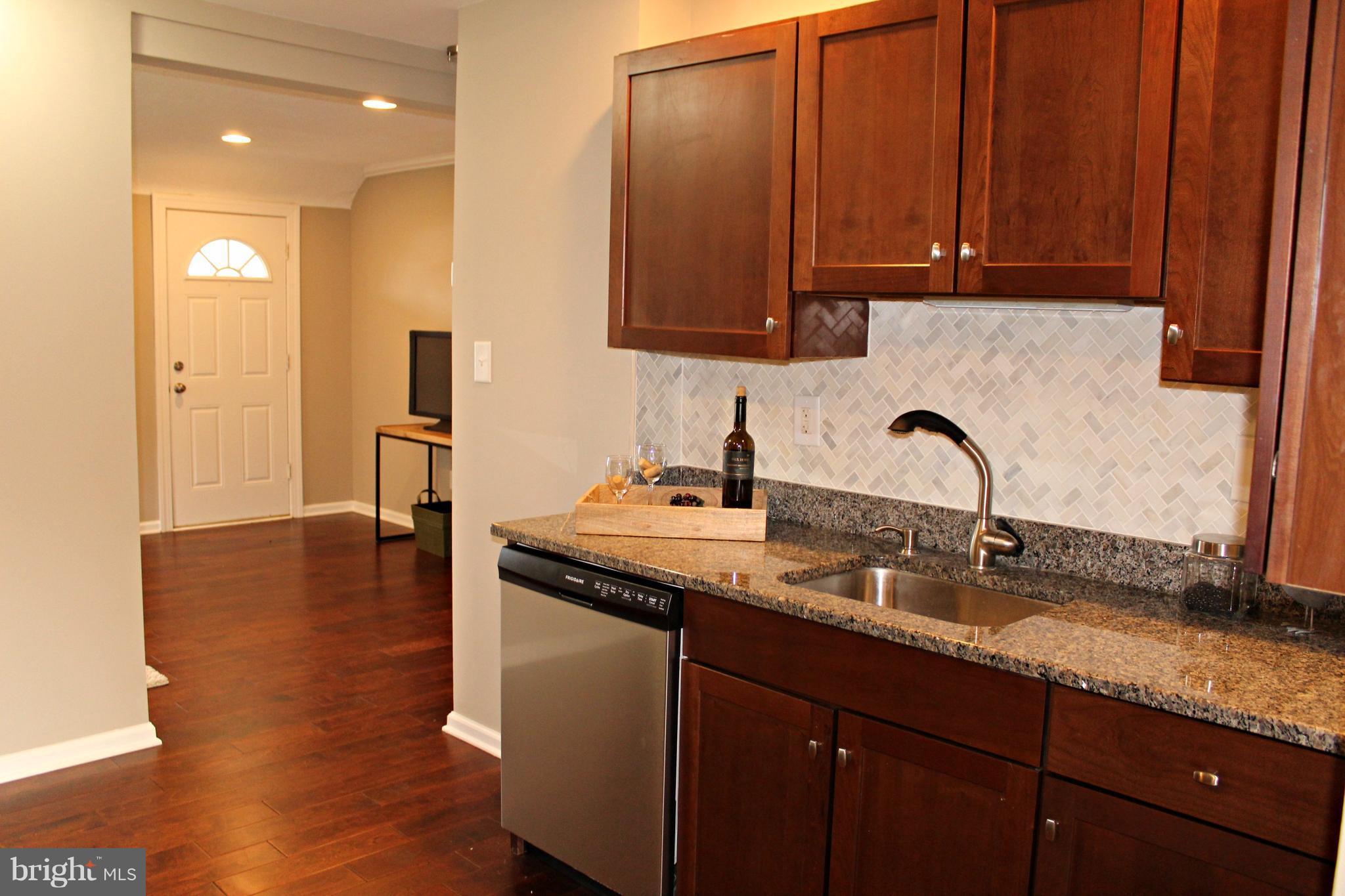 7815 Meath Road Baltimore, MD 21222 - Photo 5 of 17 a kitchen with stainless steel appliances granite countertop a sink a stove and a wooden cabinets