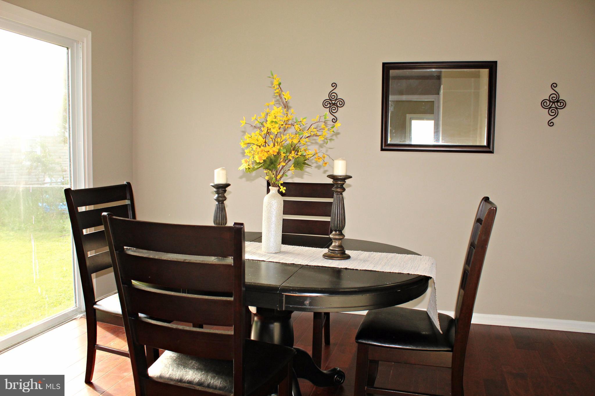 7815 Meath Road Baltimore, MD 21222 - Photo 7 of 17 a view of a dining room with furniture and wooden floor