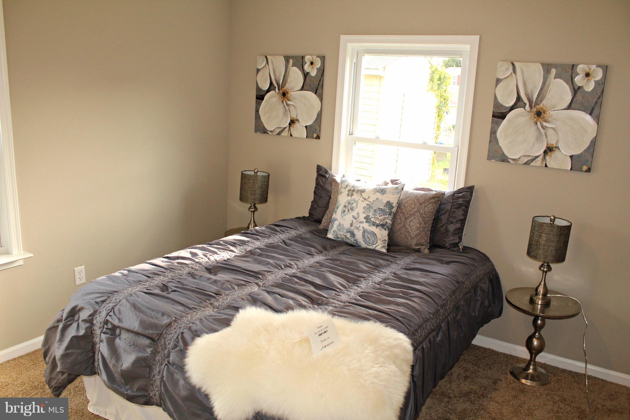 7815 Meath Road Baltimore, MD 21222 - Photo 9 of 17 a bedroom with a bed and window