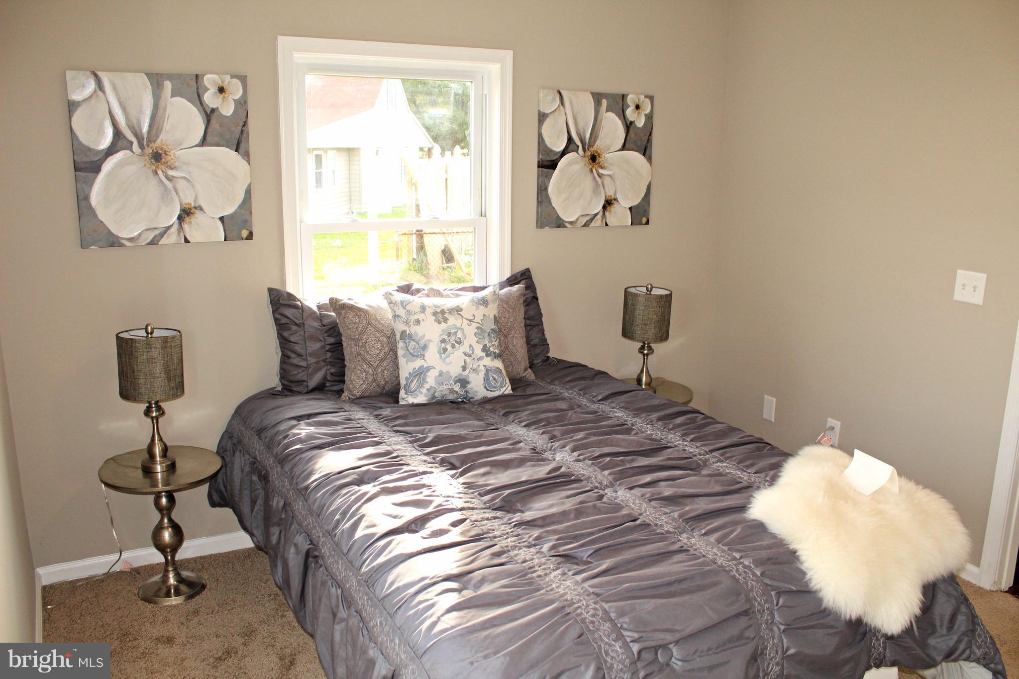 7815 Meath Road Baltimore, MD 21222 - Photo 10 of 17 a bedroom with a bed and a window