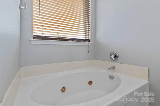 a bathroom with a shower and a glass door