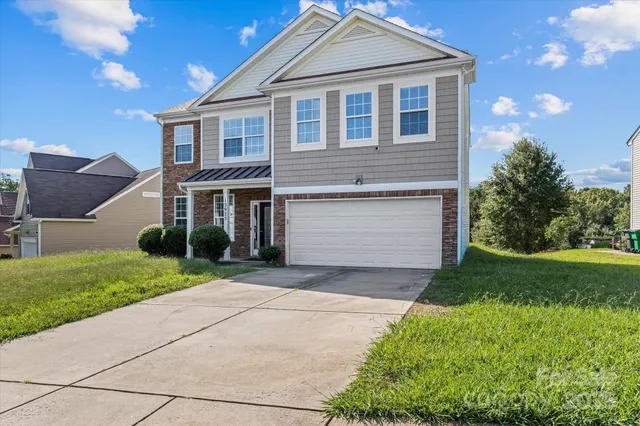 a front view of a house with a yard and garage