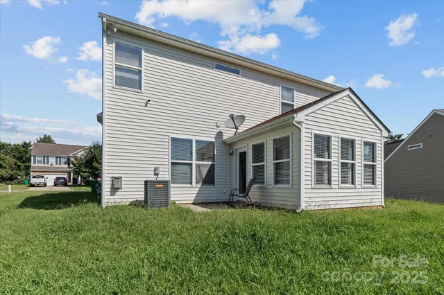 a view of a house with a backyard and a patio
