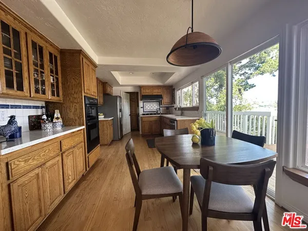 a view of a dining room with furniture and window