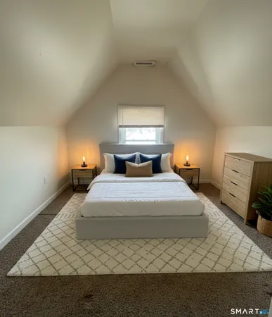 a bedroom with a bed and window