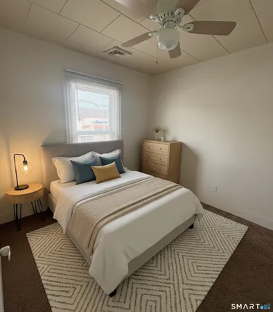a bedroom with a large bed and a chandelier