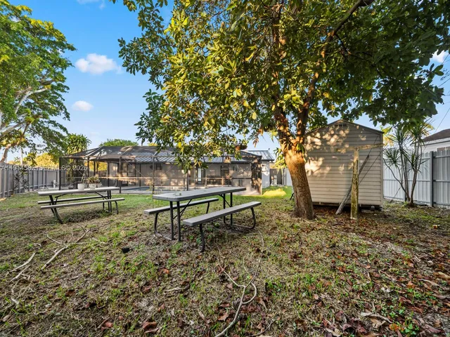 a view of a house with backyard and porch