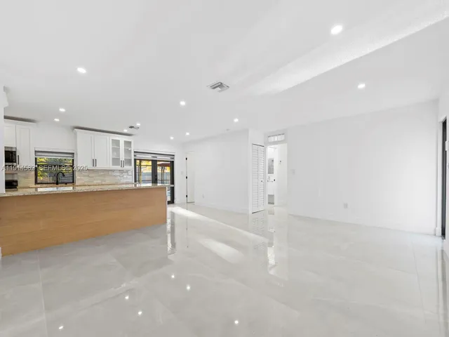 a view of kitchen and kitchen with refrigerator