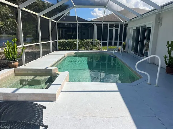 a view of small pool with seating area