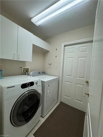 a utility room with sink dryer and washer
