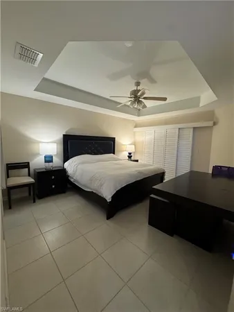 a bedroom with a bed and a lamp