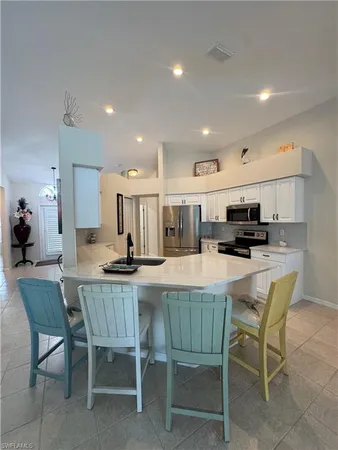 a dining room with furniture and a view of kitchen